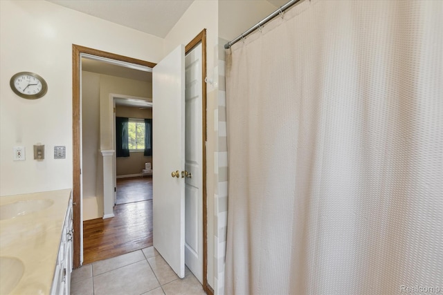 1337 Heathercrest Dr, Flint, MI 48532 - bathroom featuring double vanity, tile patterned floors, and a shower with curtain