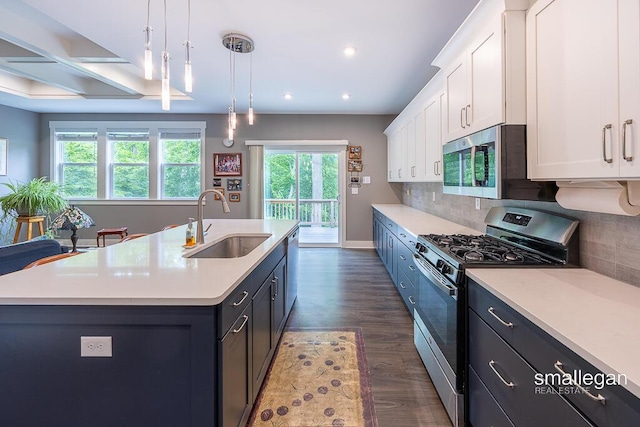 6853 Loggers Ridge Run SE, Caledonia, MI 49316 - kitchen with stainless steel appliances, white cabinetry, light countertops, dark wood-style flooring, and tasteful backsplash