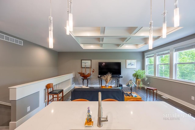 6853 Loggers Ridge Run SE, Caledonia, MI 49316 - living area with coffered ceiling, wood finished floors, and beam ceiling