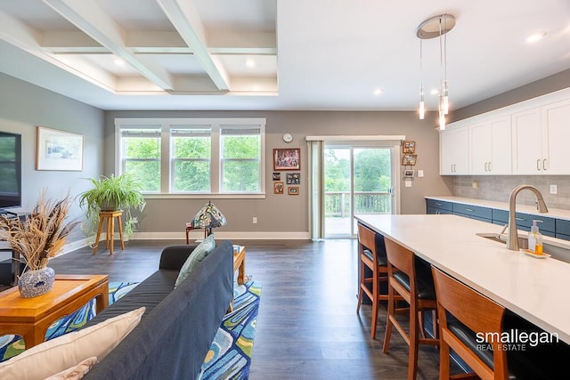 6853 Loggers Ridge Run SE, Caledonia, MI 49316 - living area featuring plenty of natural light, coffered ceiling, beamed ceiling, dark wood-style flooring, and recessed lighting
