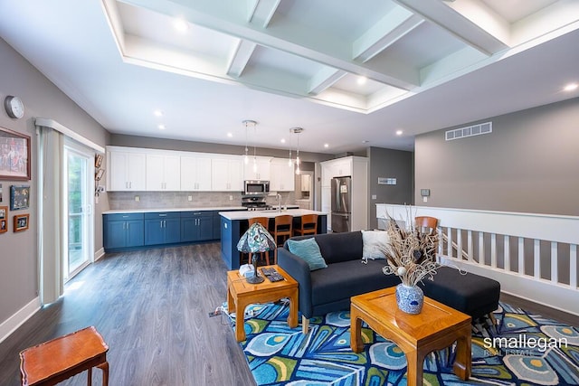 6853 Loggers Ridge Run SE, Caledonia, MI 49316 - living area with wood finished floors, coffered ceiling, recessed lighting, and beamed ceiling