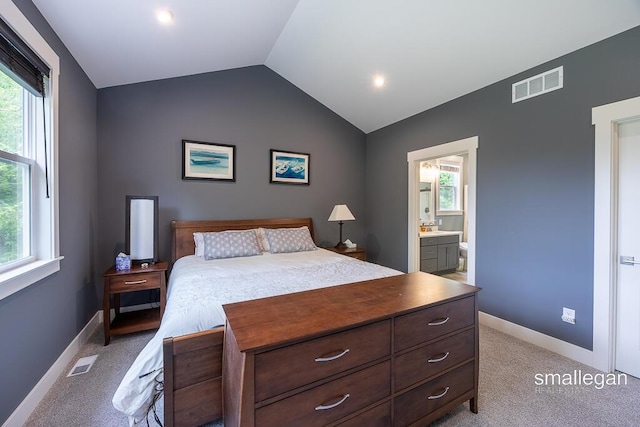 6853 Loggers Ridge Run SE, Caledonia, MI 49316 - bedroom featuring vaulted ceiling, light carpet, and ensuite bath