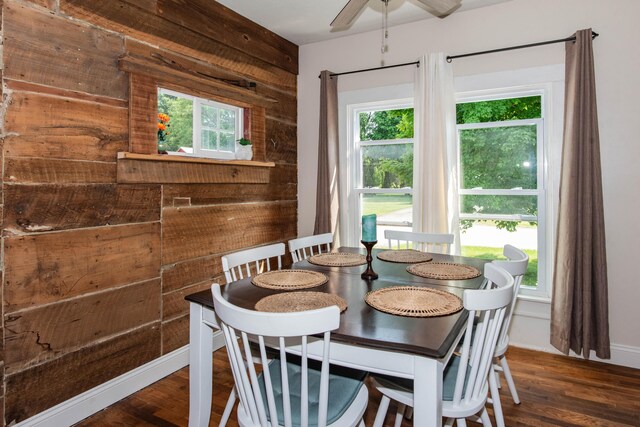 185 Race St, Constantine, MI 49042 - dining room featuring wooden walls, healthy amount of natural light, wood finished floors, and a ceiling fan