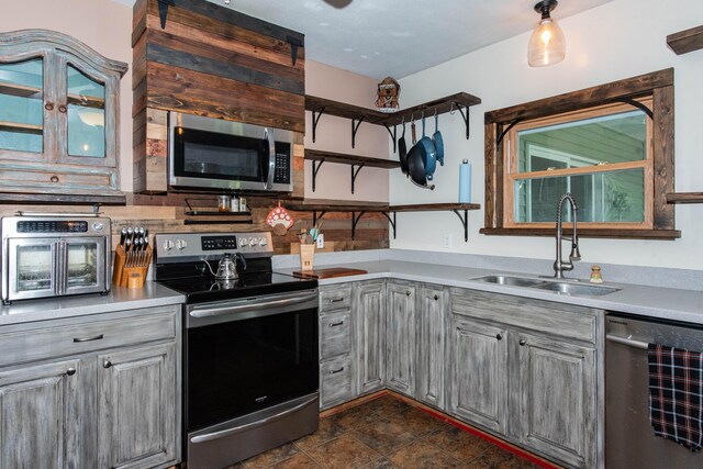 185 Race St, Constantine, MI 49042 - kitchen featuring appliances with stainless steel finishes, gray cabinetry, light countertops, and tasteful backsplash