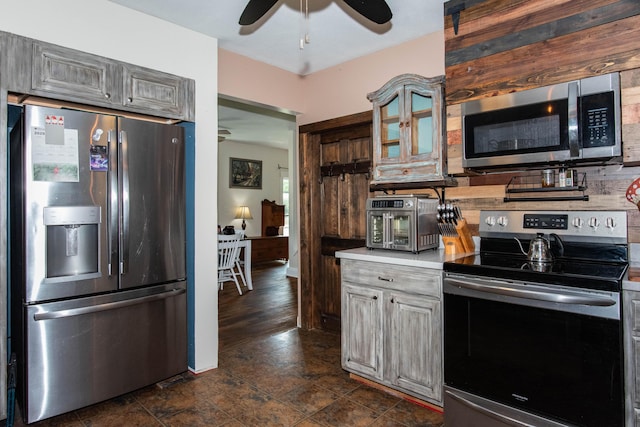 185 Race St, Constantine, MI 49042 - kitchen with stainless steel appliances, ceiling fan, glass insert cabinets, light countertops, and backsplash
