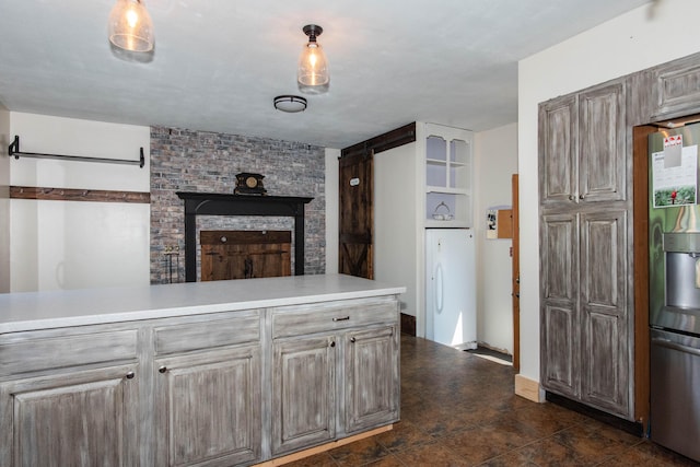 185 Race St, Constantine, MI 49042 - kitchen with freestanding refrigerator, light countertops, and a fireplace