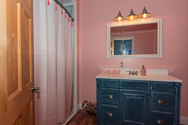 185 Race St, Constantine, MI 49042 - full bathroom with vanity, wood finished floors, and a shower with curtain