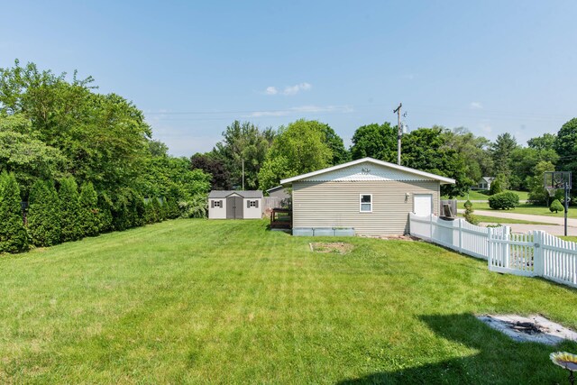 185 Race St, Constantine, MI 49042 - view of yard with a storage shed and view of wooded area