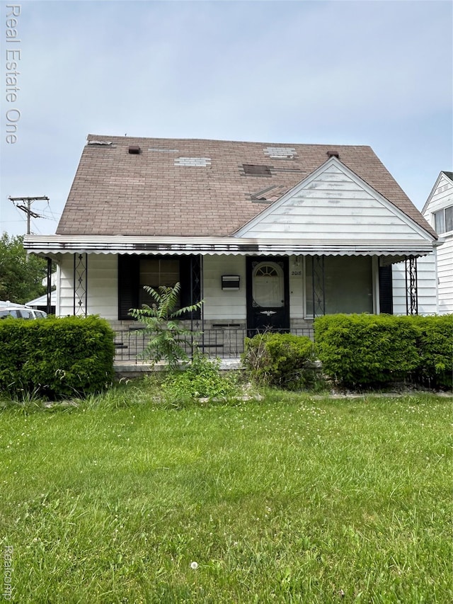2018 Goddard Rd, Lincoln Park, MI 48146 - view of front of house featuring a porch, a front lawn, and roof with shingles