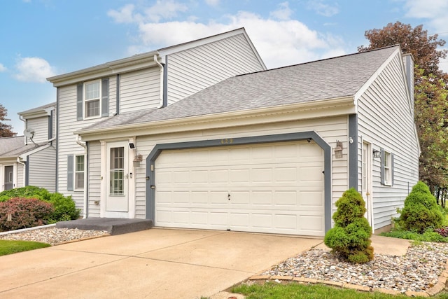 429 Zehnder Dr, Frankenmuth, MI 48734 - traditional-style home featuring concrete driveway, roof with shingles, and an attached garage