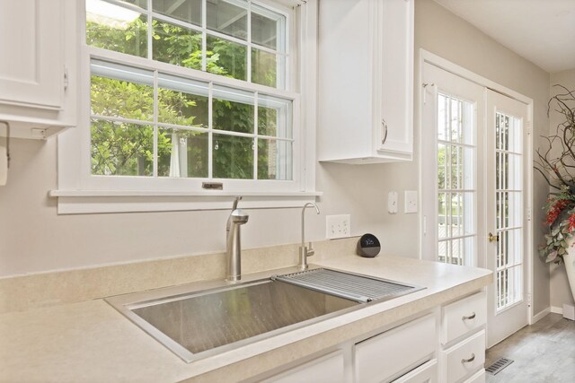 429 Zehnder Dr, Frankenmuth, MI 48734 - kitchen featuring white cabinetry, plenty of natural light, and light countertops