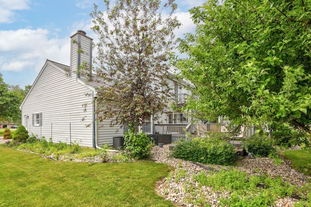429 Zehnder Dr, Frankenmuth, MI 48734 - view of property exterior featuring a yard, a chimney, and a deck