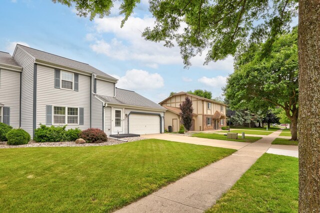 429 Zehnder Dr, Frankenmuth, MI 48734 - view of front of home with a garage, driveway, and a front lawn
