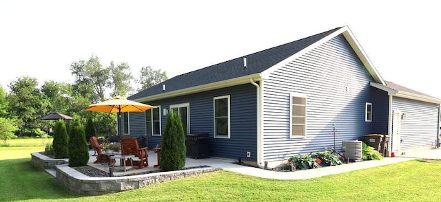 103 Cottonwood Ct, Litchfield, MI 49252 - back of property featuring a patio and a lawn