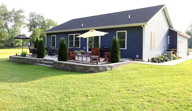 103 Cottonwood Ct, Litchfield, MI 49252 - back of house with a patio and a lawn
