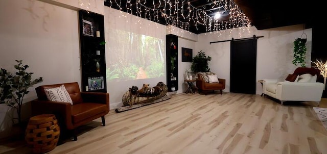 103 Cottonwood Ct, Litchfield, MI 49252 - sitting room featuring a barn door and wood finished floors