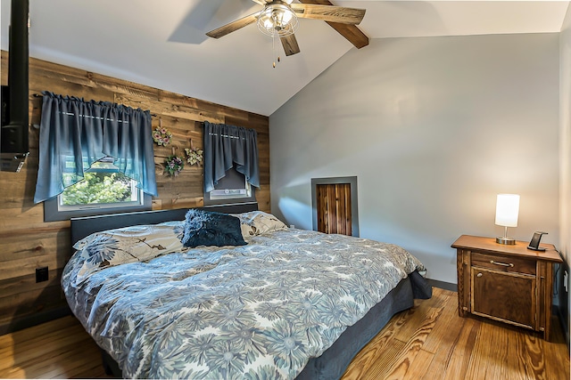 3360 Broad St, Dexter, MI 48130 - bedroom featuring wood finished floors, wooden walls, and ceiling fan