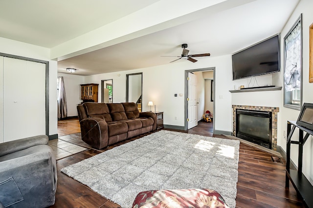 3360 Broad St, Dexter, MI 48130 - living room with a glass covered fireplace, dark wood-type flooring, ceiling fan, and stairs