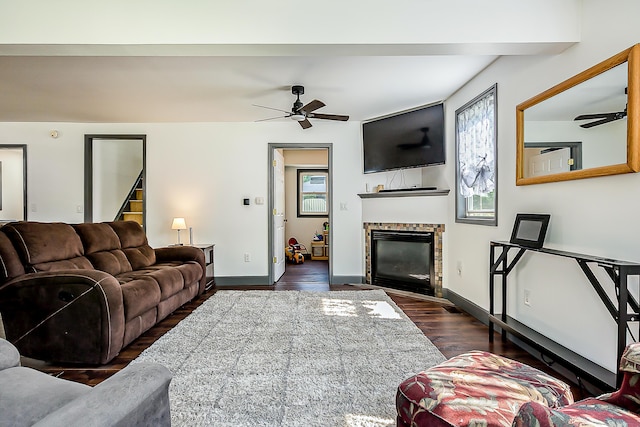 3360 Broad St, Dexter, MI 48130 - living area featuring a ceiling fan, dark wood-type flooring, a fireplace with flush hearth, and stairs