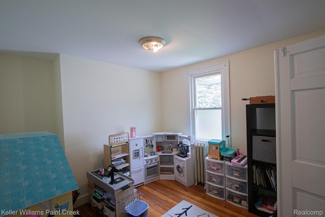 235 E Saint Clair St, Almont, MI 48003 - bedroom with wood finished floors and radiator
