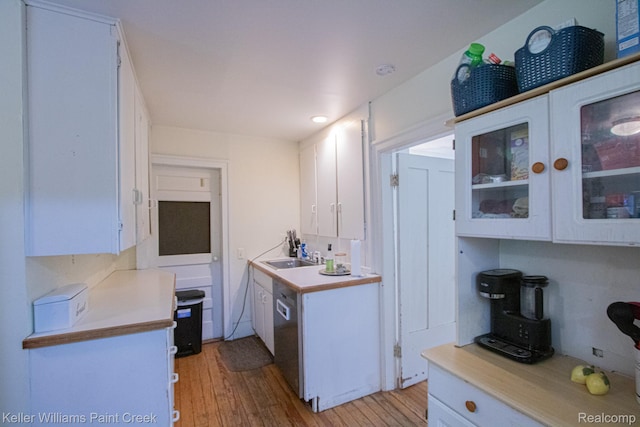 235 E Saint Clair St, Almont, MI 48003 - kitchen featuring white cabinetry, stainless steel dishwasher, light countertops, and light wood-type flooring