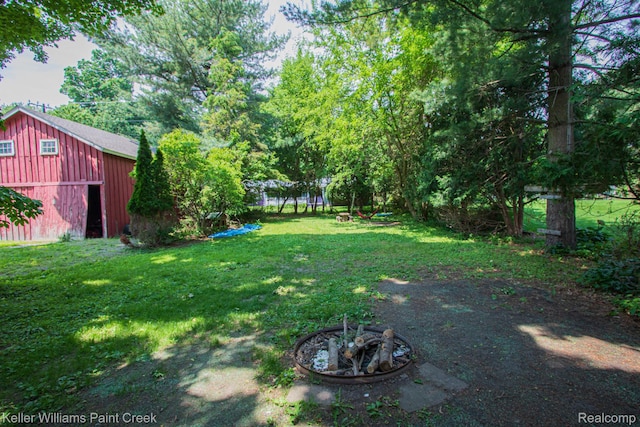 235 E Saint Clair St, Almont, MI 48003 - view of green lawn featuring an outdoor structure and a garage