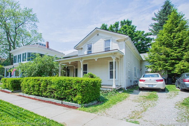 235 E Saint Clair St, Almont, MI 48003 - view of front of property featuring a porch and gravel driveway