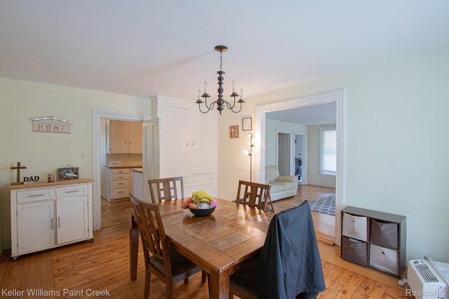 235 E Saint Clair St, Almont, MI 48003 - dining space with a chandelier and light wood finished floors