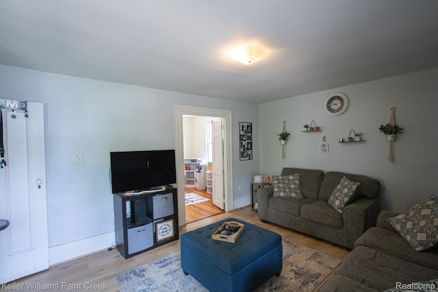 235 E Saint Clair St, Almont, MI 48003 - living room featuring light wood-style floors and baseboards
