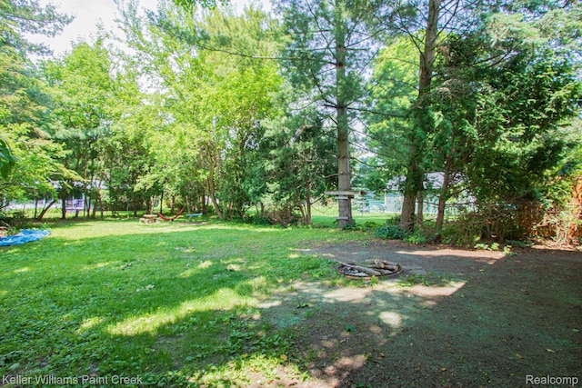235 E Saint Clair St, Almont, MI 48003 - view of grassy yard featuring an outdoor fire pit