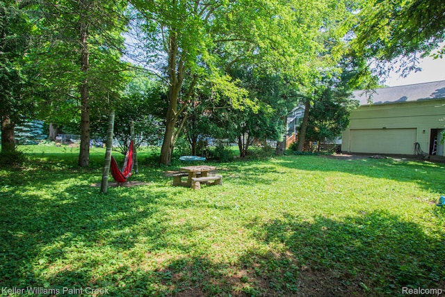 235 E Saint Clair St, Almont, MI 48003 - view of grassy yard featuring an attached garage