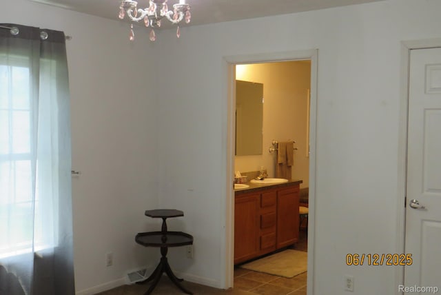 10571 Baraga St, Taylor, MI 48180 - corridor with a chandelier and light tile patterned floors