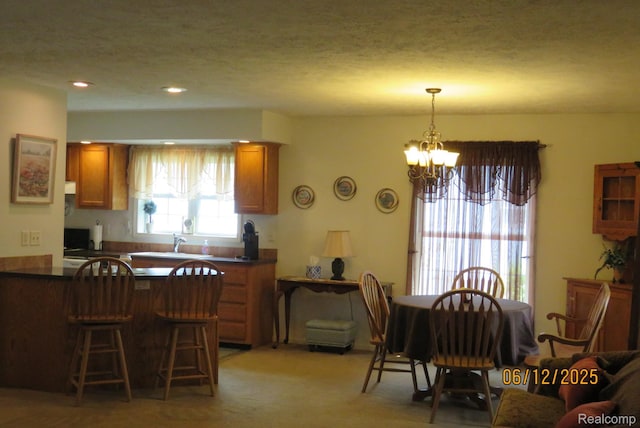 10571 Baraga St, Taylor, MI 48180 - kitchen featuring dark countertops, a chandelier, brown cabinets, and recessed lighting