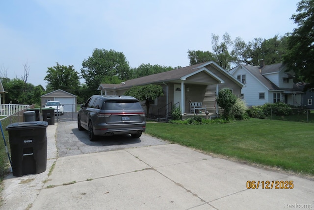 10571 Baraga St, Taylor, MI 48180 - view of front facade featuring a front lawn, an outbuilding, covered porch, and a detached garage