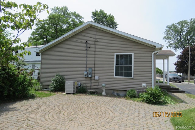 10571 Baraga St, Taylor, MI 48180 - view of side of home featuring a central AC unit and a patio area