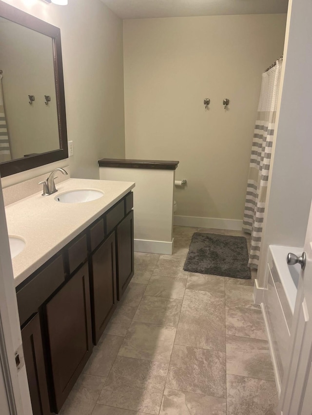 727 Wild Flower Ct, Wayland, MI 49348 - bathroom with double vanity and a shower with shower curtain
