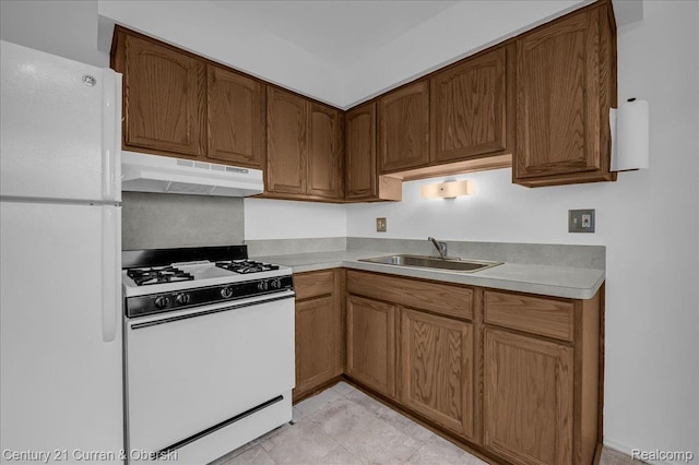 23505 Baker St, Taylor, MI 48180 - kitchen featuring white appliances, under cabinet range hood, light countertops, and brown cabinetry