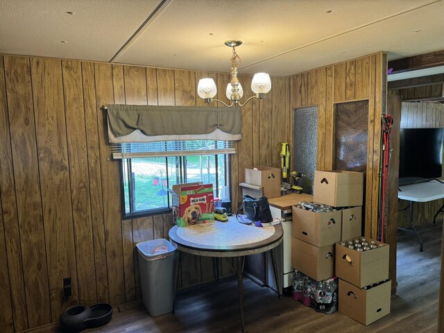 1321 Ziggy Rd, Farwell, MI 48622 - dining room featuring wooden walls, wood finished floors, and a chandelier