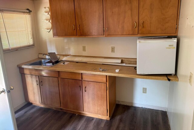 1321 Ziggy Rd, Farwell, MI 48622 - kitchen with dark wood-style floors, fridge, light countertops, and brown cabinets