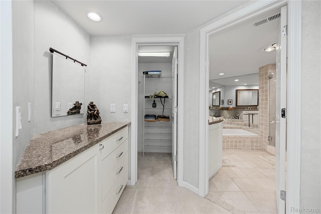 3565 Port Cove Dr Unit 68, Waterford, MI 48328 - full bathroom featuring a garden tub, tiled shower, vanity, a spacious closet, and recessed lighting