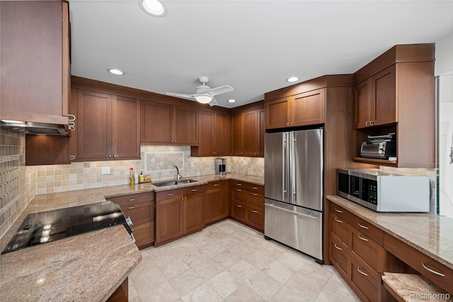 3565 Port Cove Dr Unit 68, Waterford, MI 48328 - kitchen with appliances with stainless steel finishes, backsplash, light stone counters, a ceiling fan, and recessed lighting