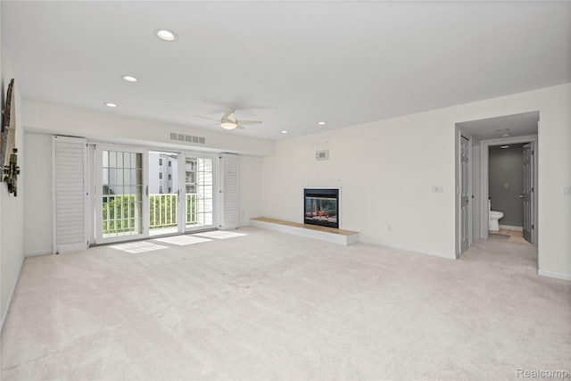 3565 Port Cove Dr Unit 68, Waterford, MI 48328 - unfurnished living room with a ceiling fan, light colored carpet, a glass covered fireplace, and recessed lighting