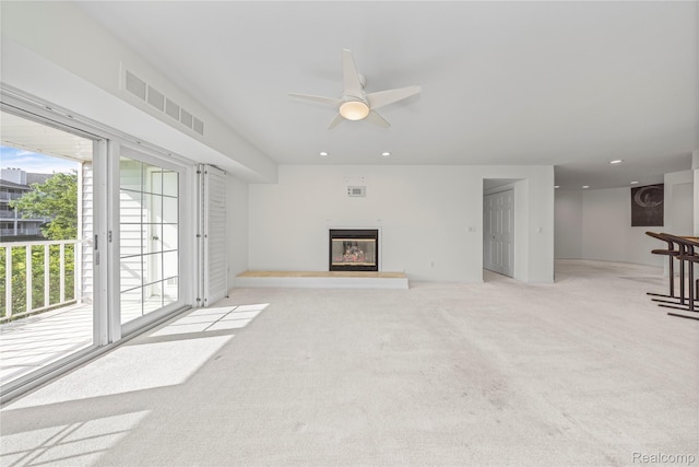 3565 Port Cove Dr Unit 68, Waterford, MI 48328 - unfurnished living room featuring healthy amount of natural light, ceiling fan, light colored carpet, a glass covered fireplace, and recessed lighting