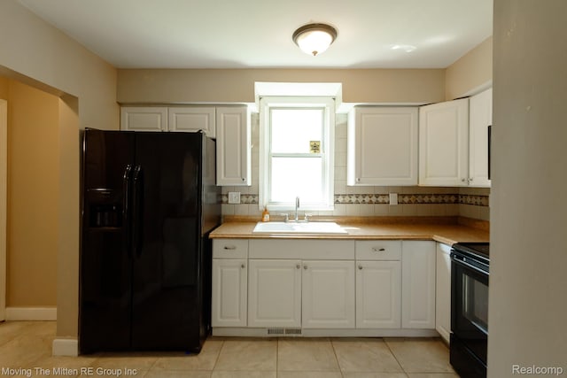 11954 Timken Ave, Warren, MI 48089 - kitchen with black appliances, white cabinets, and light tile patterned flooring