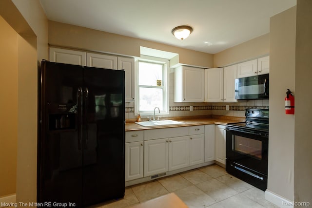 11954 Timken Ave, Warren, MI 48089 - kitchen featuring black appliances, white cabinets, and light tile patterned floors