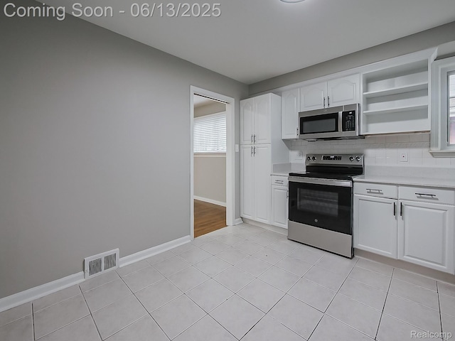 22854 Lingemann St, Saint Clair Shores, MI 48080 - kitchen featuring stainless steel appliances, white cabinets, light countertops, open shelves, and backsplash