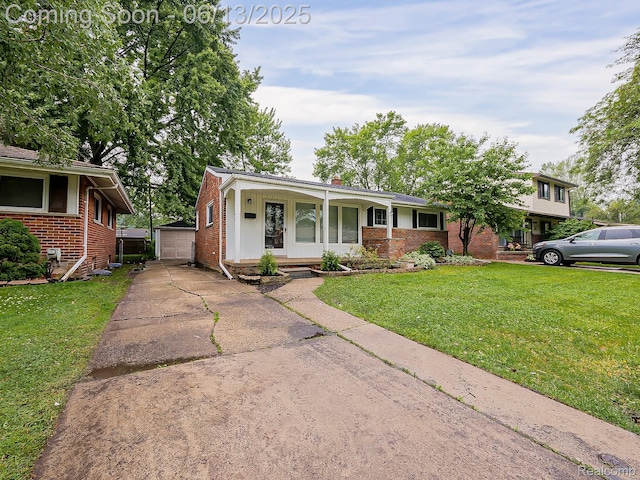 22854 Lingemann St, Saint Clair Shores, MI 48080 - view of front facade with brick siding, an outdoor structure, a front lawn, a garage, and driveway