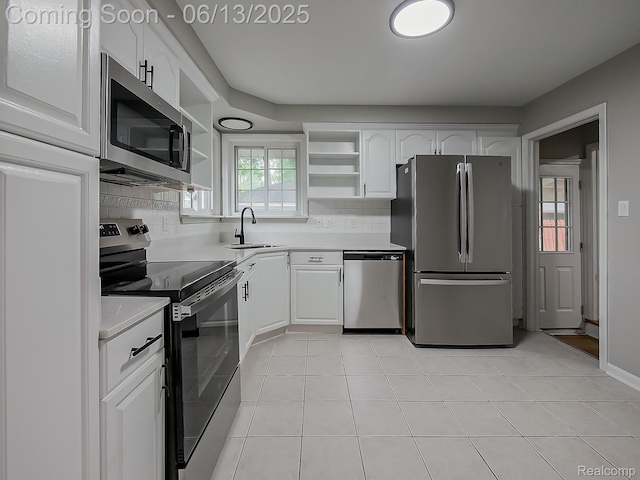 22854 Lingemann St, Saint Clair Shores, MI 48080 - kitchen with stainless steel appliances, open shelves, white cabinets, backsplash, and light countertops
