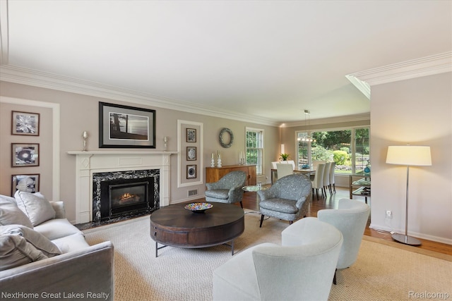 1831 Hampden Rd, Flint, MI 48503 - living area with crown molding, light wood finished floors, and a premium fireplace
