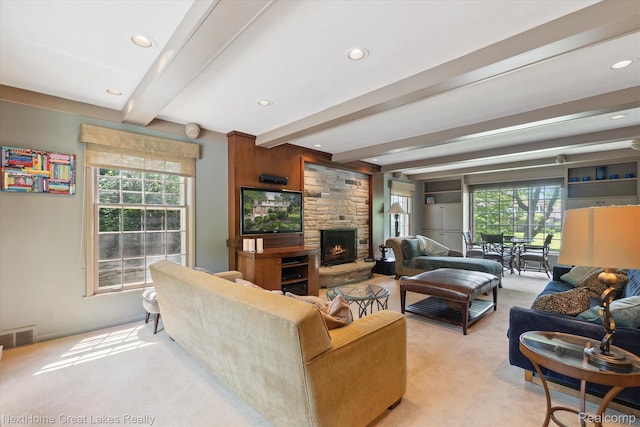 1831 Hampden Rd, Flint, MI 48503 - living area with light colored carpet, beamed ceiling, plenty of natural light, a fireplace, and recessed lighting